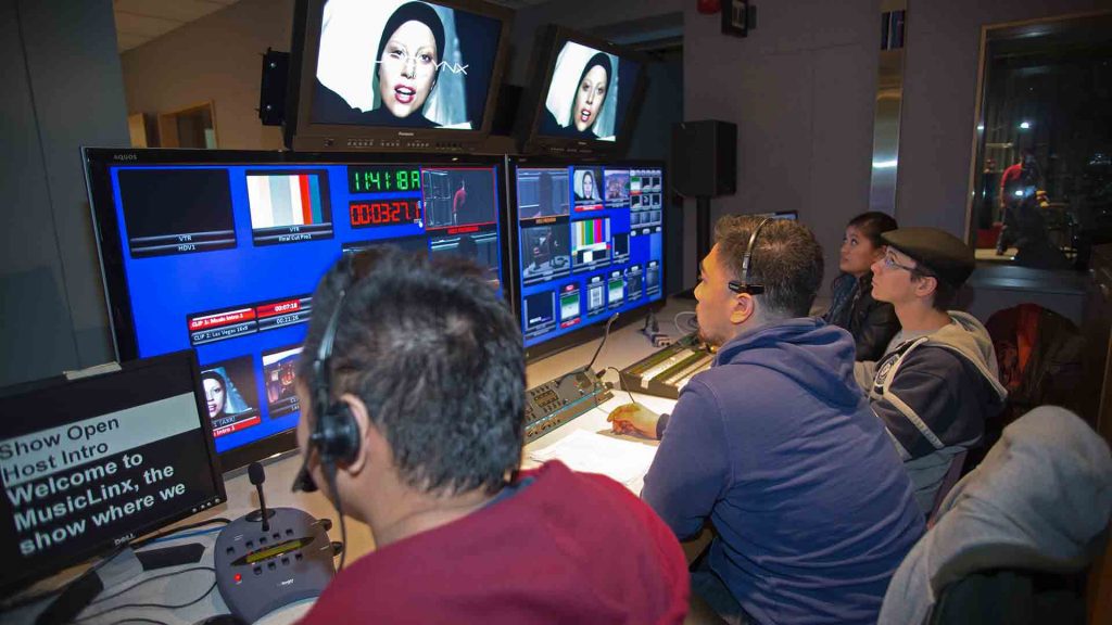 students in the broadcast studio control room