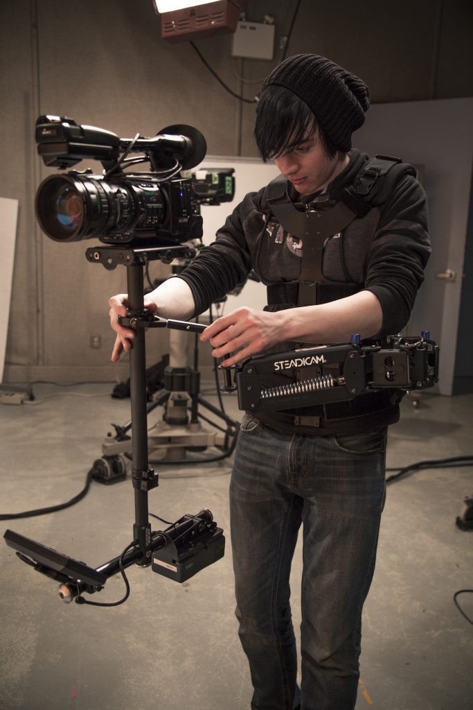student operating a camera